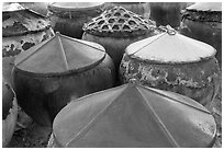 Amphorae for storage of traditional Vietnamese fish sauce Nuoc Mam. Mui Ne, Vietnam ( black and white)