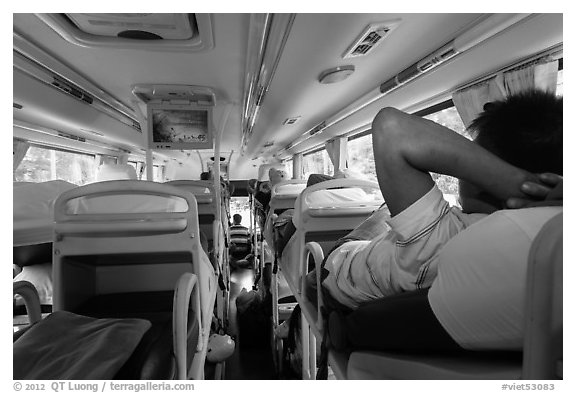 Inside bus with reclining seats for sleeping. Vietnam (black and white)