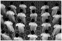 Worshippers dressed in white stand in rows in Cao Dai temple. Tay Ninh, Vietnam ( black and white)