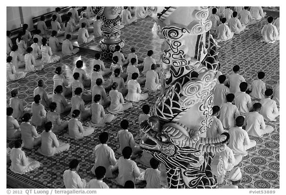 Column and worshippers, Cao Dai Holy See temple. Tay Ninh, Vietnam (black and white)