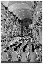 Rows of worshippers in Cao Dai Holy See. Tay Ninh, Vietnam (black and white)