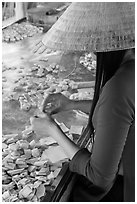 Woman wearing conical hat wrapping coconut candy, Phoenix Island. My Tho, Vietnam (black and white)