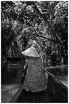 Woman rowing boat under jungle canopy, Phoenix Island. My Tho, Vietnam ( black and white)