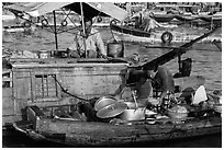 Woman serving food across boats, Cai Rang floating market. Can Tho, Vietnam (black and white)