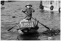 Woman paddling boat with breads, Cai Rang floating market. Can Tho, Vietnam (black and white)