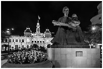 Ho Chi Minh as teacher bronze by Diep Minh Chau and City Hall by night. Ho Chi Minh City, Vietnam (black and white)