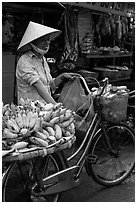 Woman selling bananas from bicycle. Ho Chi Minh City, Vietnam (black and white)