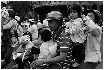 Family on motorbike watching musical performance. Ho Chi Minh City, Vietnam ( black and white)
