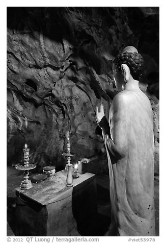 Buddha statue in narrow cave, Marble Mountains. Da Nang, Vietnam (black and white)
