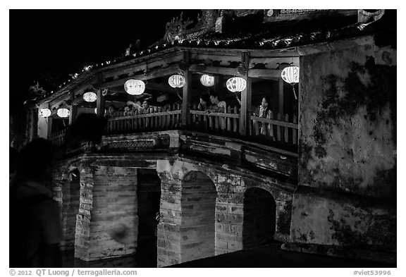 People enjoy Japanese Bridge lit solely by lanterns. Hoi An, Vietnam (black and white)