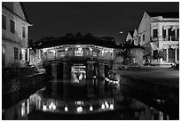 Covered Japanese Bridge reflected in canal by night. Hoi An, Vietnam ( black and white)