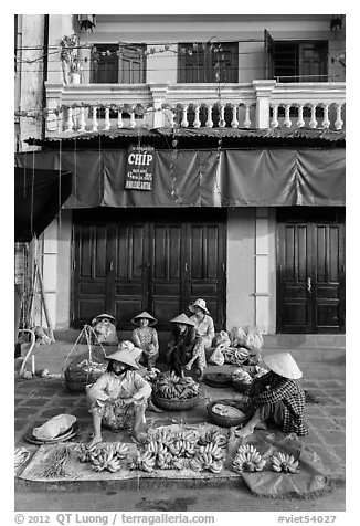 Banana vendors and historic house. Hoi An, Vietnam (black and white)