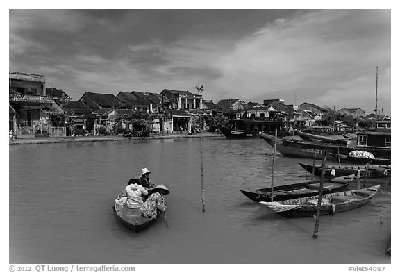 Women crossing the Thu Bon River in a rowboat. Hoi An, Vietnam (black and white)