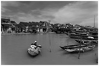 Women crossing the Thu Bon River in a rowboat. Hoi An, Vietnam (black and white)