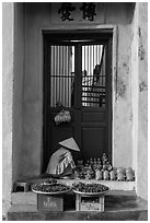Ceramics vendor, blue temple door. Hoi An, Vietnam ( black and white)