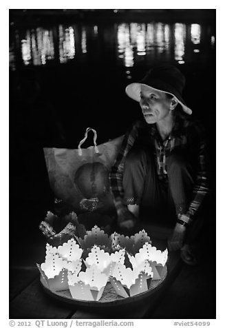Woman selling floating candles at night. Hoi An, Vietnam (black and white)