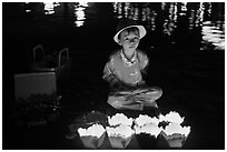 Boy selling candle lanterns at night. Hoi An, Vietnam (black and white)