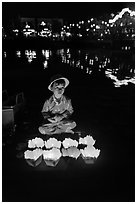 Boy selling candle lanterns by the river. Hoi An, Vietnam ( black and white)