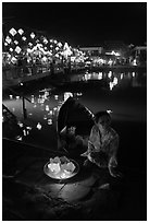Woman selling candle lanterns by the bridge. Hoi An, Vietnam ( black and white)