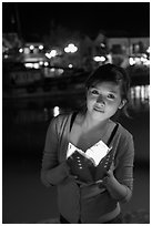 Woman holding candle box at night. Hoi An, Vietnam ( black and white)