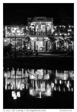 Waterfront house reflected in river at night. Hoi An, Vietnam (black and white)