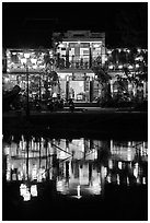 Waterfront house reflected in river at night. Hoi An, Vietnam ( black and white)
