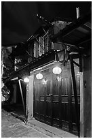 Townhouse with wooden doors lighted by paper lanterns. Hoi An, Vietnam ( black and white)