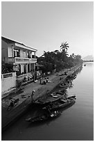 Waterfront and quay with vendors at sunrise. Hoi An, Vietnam (black and white)