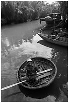 Man in circular boat near Cam Kim Village. Hoi An, Vietnam (black and white)
