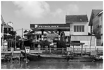 Road and river petrol station. Hoi An, Vietnam (black and white)