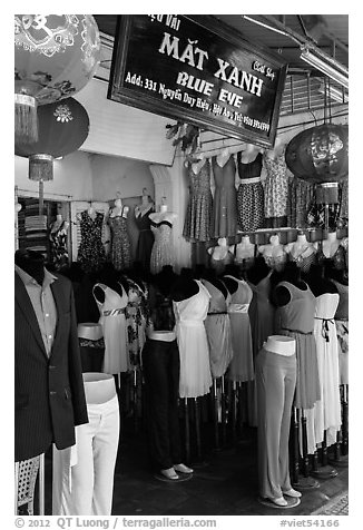 Colorful outfits and lanterns in textile shop. Hoi An, Vietnam (black and white)