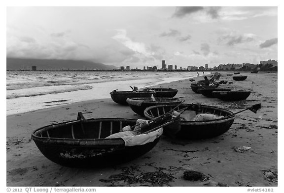 Coracle boats and city skyline. Da Nang, Vietnam (black and white)