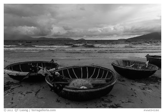 Coracle boats on beach during storm. Da Nang, Vietnam