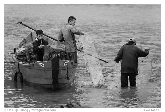 Men operating fish traps. Vietnam (black and white)