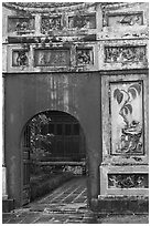 Palace gate with ceramic decorations, citadel. Hue, Vietnam ( black and white)