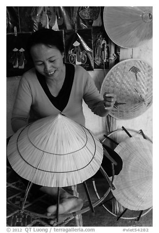 Woman crafting conical hat. Hue, Vietnam