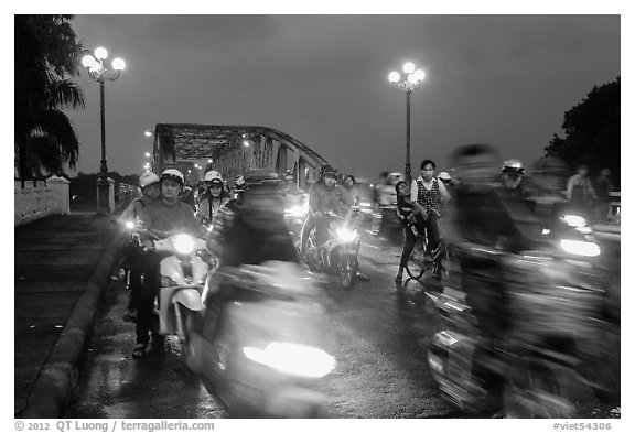 Night motorcyle traffic out of Trang Tien bridge. Hue, Vietnam (black and white)
