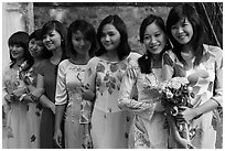 Row of women in Ao Dai, Temple of the Litterature. Hanoi, Vietnam ( black and white)