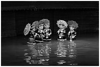 Water puppets (5 characters with umbrellas), Thang Long Theatre. Hanoi, Vietnam ( black and white)