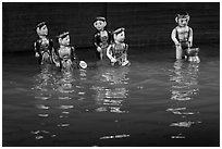 Water puppets (5 characters with musical instruments), Thang Long Theatre. Hanoi, Vietnam ( black and white)