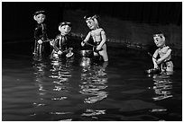 Water puppets (4 characters with musical instruments), Thang Long Theatre. Hanoi, Vietnam ( black and white)