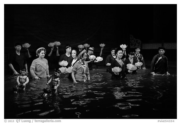 Water puppet artists standing in pool after performance, Thang Long Theatre. Hanoi, Vietnam (black and white)