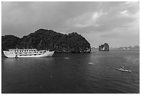 Tour boat and sea kayaks. Halong Bay, Vietnam ( black and white)