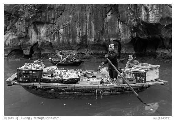 Grocer on rowboat. Halong Bay, Vietnam (black and white)