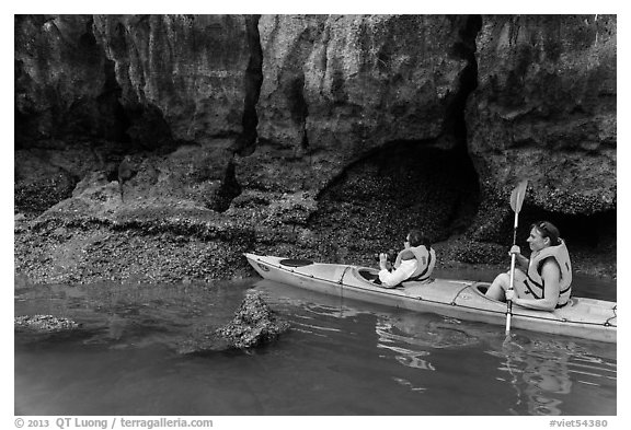 Sea kayakers approaching monkey. Halong Bay, Vietnam
