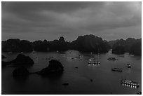 Tour boats lights and islands from above at night. Halong Bay, Vietnam (black and white)