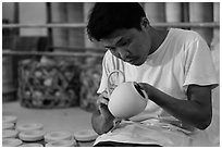 Man assembling ceramic tea pot in workshop. Bat Trang, Vietnam (black and white)