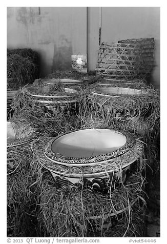 Ceramic vases wrapped in hay in storeroom. Bat Trang, Vietnam