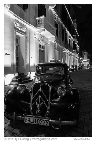 Vintage car in front of Metropole hotel at night. Hanoi, Vietnam