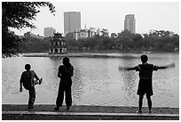 People exercising in front of Turtle Tower, Hoang Kiem Lake. Hanoi, Vietnam (black and white)